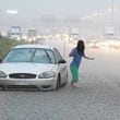 090921 Lilburn - RUSH HOUR MANIA - A female motorist abandons her flooded vehicle on I-75 South at spagetti junction as part of the highway becomes covered with water during rush hour on Monday, Sept. 21, 2009. A Georgia State patrolman arrived on the scene to help aid the motorist who declined to be identified.  Curtis Compton, ccompton@ajc.com