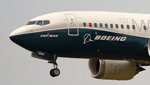 FILE - A Boeing 737 Max jet, piloted by Federal Aviation Administration (FAA) chief Steve Dickson, prepares to land at Boeing Field following a test flight on Sept. 30, 2020 in Seattle. On Sunday, July 7, 2024, the Justice Department said Boeing has agreed to plead guilty to a criminal fraud charge stemming from two deadly crashes of 737 Max jetliners. (AP Photo/Elaine Thompson, File)