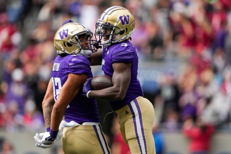 Washington wide receiver Giles Jackson, right, celebrates his touchdown with wide receiver Denzel Boston (12) against Washington State during the first half of an NCAA college football game Saturday, Sept. 14, 2024, in Seattle. (AP Photo/Lindsey Wasson)