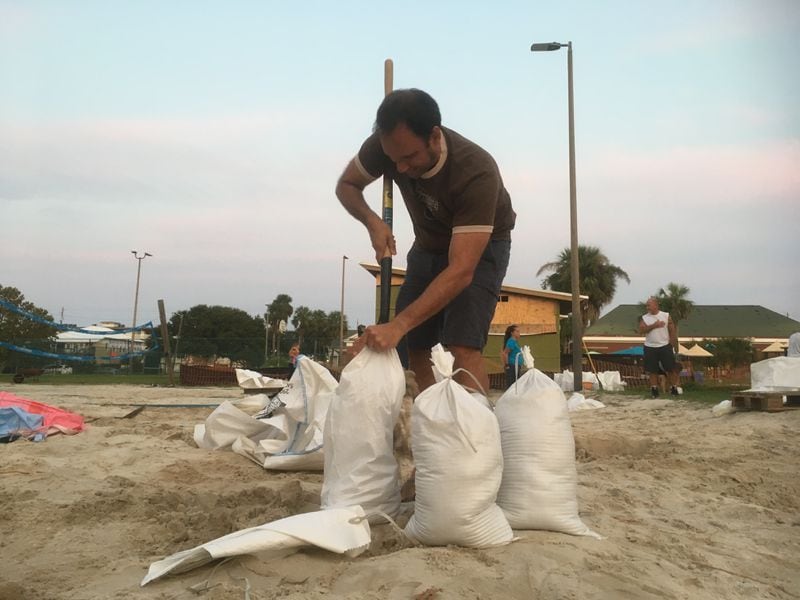 TYBEE ISLAND - Adam Demico was among the residents hurriedly stuffing sandbags ahead of Hurricane Irma. (Jennifer Brett/ jbrett@ajc.com)