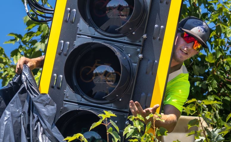 Blake Hales with Reedwick LLC installed traffic signal lights in the heat at Memorial Drive and Martin Street SE in Atlanta dealing with temperatures close to record highs on Tuesday, June 25, 2024. The highest temperature recorded on June 25 was 99 degrees set in 1988. Tuesday, the city was expected to top out around 97 degrees. The average is 88 degrees. (John Spink/AJC)