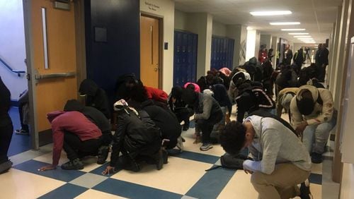 Students at Washington High School in Atlanta planned a silent protest by taking a knee and bowing in the hallways to honor 17 victims in the Marjorie Stoneman Douglas shooting in Parkland, Fla., in 2018. Walkouts are being planned by students in schools on Thursday and Friday to push for tougher gun safety measures in the wake of the Apalachee High School shooting. (Latisha Gray/X)