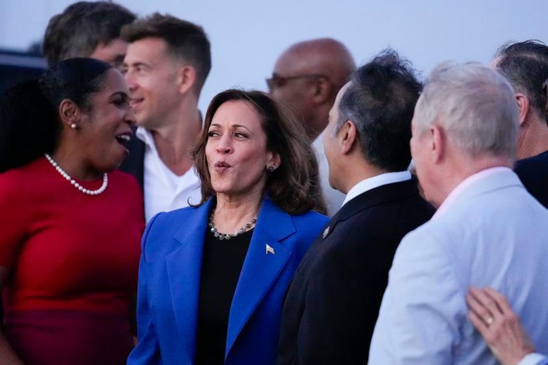 Democratic presidential nominee Vice President Kamala Harris, center, met with supporters on the tarmac while arriving at O'Hare International Airport in Chicago on Sunday, Aug. 18, 2024. (AP Photo/Brynn Anderson)