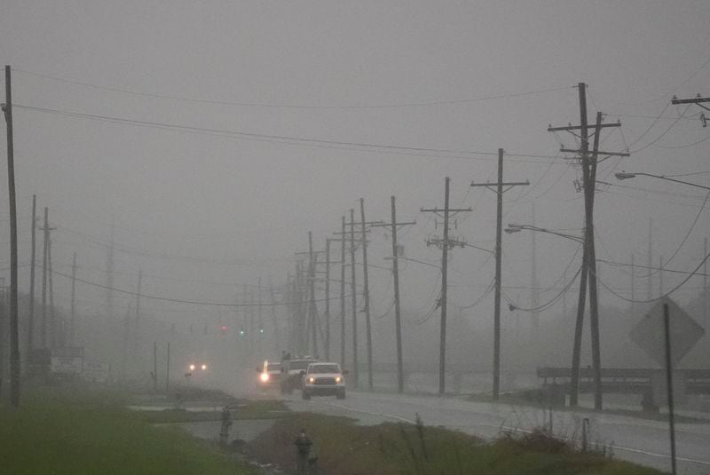 Cars drive through rain bands along Peter Rd., just outside New Orleans, ahead of Tropical Storm Francine, in Harvey, La., Tuesday, Sept. 10, 2024. (AP Photo/Gerald Herbert)