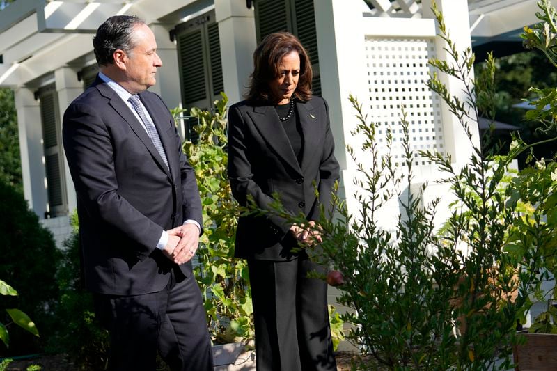 Democratic presidential nominee Vice President Kamala Harris, right, and second gentleman Doug Emhoff stand after planting a memorial tree on the grounds of the Vice President's residence in Washington on Monday, Oct. 7, 2024, to honor the victims and mark one year since the Oct. 7, 2023, Hamas attack on Israel. (AP Photo/Ben Curtis)