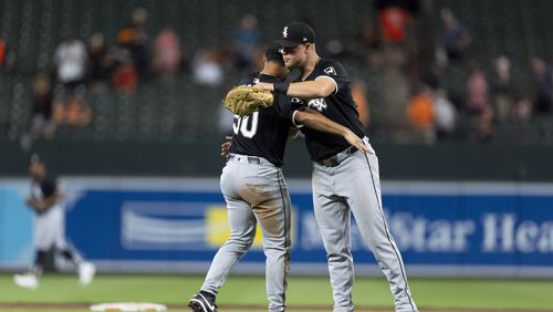 Chicago White Sox third baseman Lenyn Sosa, left, and relief pitcher Justin Anderson, right, celebrate their team's win over the Baltimore Orioles after a baseball game, Wednesday, Sept. 4, 2024, in Baltimore. (AP Photo/Stephanie Scarbrough)