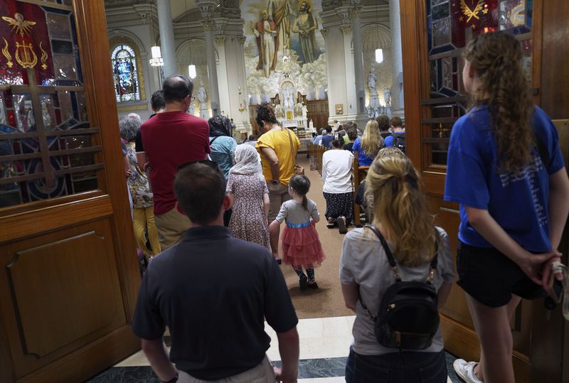 Families pack into St. Peter Church for a prayer service as part of the National Eucharistic Pilgrimage in Steubenville, Ohio, Friday, June 21, 2024. The pilgrimage began in four separate locations, California, Connecticut, Minnesota and Texas, and will conclude with the National Eucharistic Congress in Indianapolis in mid-July. (AP Photo/Jessie Wardarski)