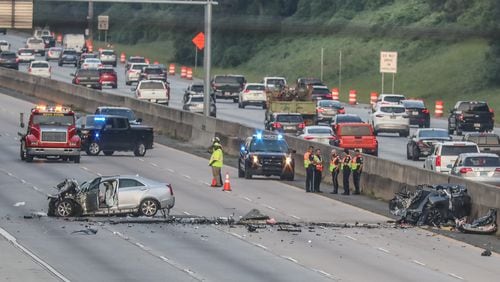 Authorities block the northbound lanes of Ga. 400 at Holcomb Bridge Road early Tuesday morning to investigate a deadly crash.