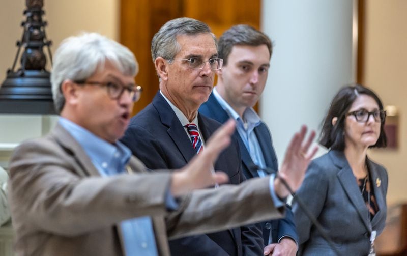 (Left to right) Gabriel Sterling speaks at a news conference on Monday while Secretary of State Brad Raffensperger, Blake Evans and Noula Zaharis listen.