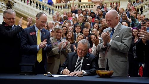 April 16, 2015 Atlanta, GA: Gov. Nathan Deal signs House Bill 1 Thursday amid a crowd of supporters. The bill now allows the limited use of cannabis oil to treat disorders that include cancer, sickle cell disease and epilepsy as long as a physician signs off. BRANT SANDERLIN/BSANDERLIN@AJC.COM