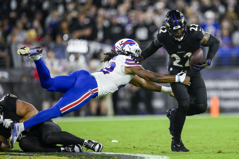 Baltimore Ravens running back Derrick Henry, right, runs with the ball as Buffalo Bills linebacker Dorian Williams tries to stop him during the first half of an NFL football game, Sunday, Sept. 29, 2024, in Baltimore. (AP Photo/Nick Wass)