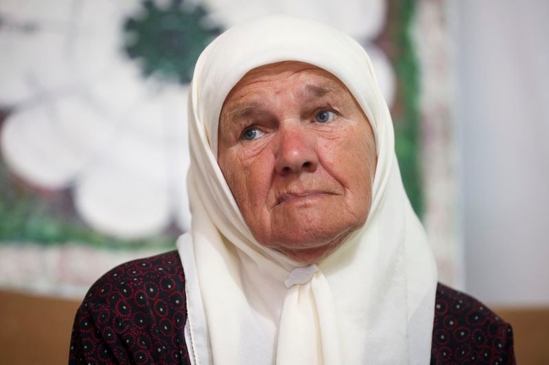 Mejra Djogaz, member of the association Mothers of Srebrenica, watches the United Nations General Assembly session where voting on a draft resolution declaring July 11 the International Day of Reflection and Commemoration of the 1995 genocide in Srebrenica takes place in Potocari, Bosnia, Thursday, May 23, 2024. (AP Photo/Armin Durgut)