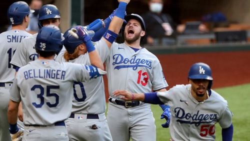 Dodgers first baseman Max Muncy (13) celebrates with teammates his grand slam that capped an 11-run first inning in Game 3 of the National League Championship Series Wednesday, Oct. 14, 2020, at Globe Life Field in Arlington, Texas. (Curtis Compton / Curtis.Compton@ajc.com)