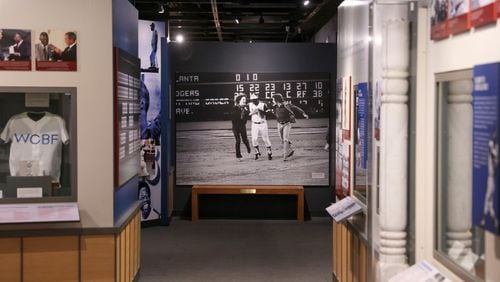 The photograph taken by Ron Sherman shows Hank Aaron greeted by a pair of fans as he rounds the bases following his record-breaking 715th career home run , April 8, 1974, in the exhibit, The Hank Aaron: Chasing The Dream, at the National Baseball Hall of Fame, Thursday, May 23, 2024, in Cooperstown, NY. This is one of only two exhibits in the museum dedicated to telling the story of a single player. (Jason Getz/The Atlanta Journal-Constitution/TNS)