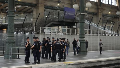 FILE - Police officers patrol inside the Gare du Nord train station at the 2024 Summer Olympics, Friday, July 26, 2024, in Paris, France. The French government says multiple telecommunications lines have been hit by acts of vandalism, affecting fiber lines and fixed and mobile phone lines as cities around France are hosting events for the 2024 Paris Olympics. (AP Photo/Mark Baker, File)