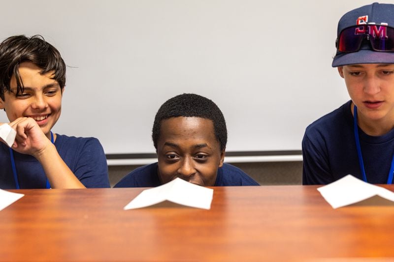 (L-R) Aaron Zunzunegi, 13, Jaki Fountain, 14, and Luke Hamm, 13, learn about the Bernoulli principle in an experiment as part of ASPIRE Aviation Summer Camp at Dekalb-Peachtree Airport in Chamblee on Thursday, June 29, 2023. (Arvin Temkar / arvin.temkar@ajc.com)