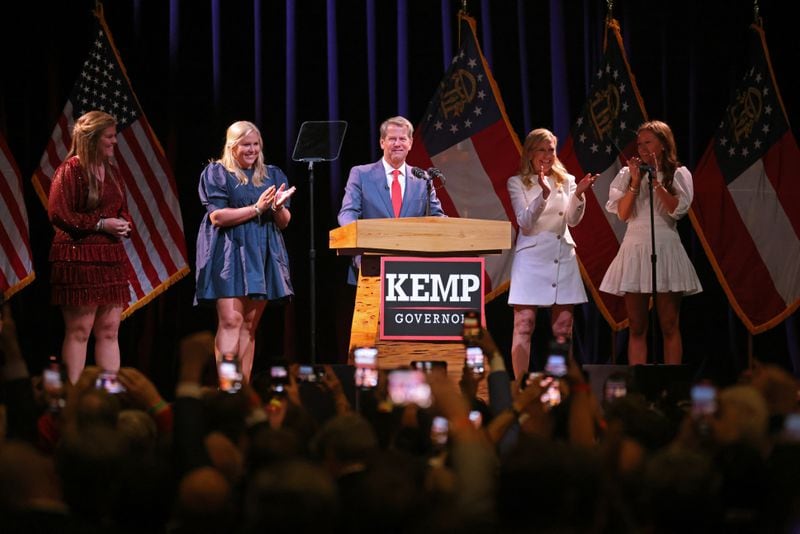 Gov. Brian Kemp, joined by his family, greets supporters in Atlanta after being reelected Tuesday. Kemp’s wife, Marty Kemp, is second from right. Also shown are Kemp’s three daughters from left to right; Lucy Kemp, Jarrett Kemp, and Amy Porter, far right. (Jason Getz/AJC)