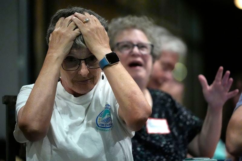 Karen Sellinger, left, and her partner, Bonnie Weissberg, of South Portland, Maine, reacts to a comment by Republican presidential candidate former President Donald Trump during the presidential debate with President Joe Biden, during a watch party at Broadway Bowl, Thursday, June 27, 2024, in South Portland, Maine. (AP Photo/Robert F. Bukaty)