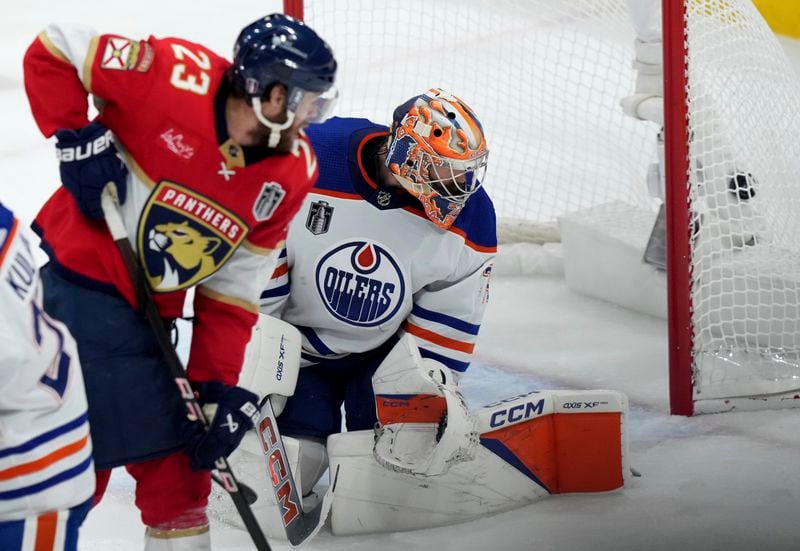 Florida Panthers forward Carter Verhaeghe (23) watches the puck hit the back of the net behind Edmonton Oilers goaltender Stuart Skinner, right, during the second period of Game 7 of the NHL hockey Stanley Cup Final in Sunrise, Fla., Monday, June 24, 2024. (Nathan Denette/The Canadian Press via AP)