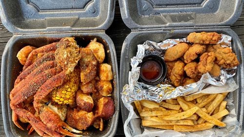 This takeout order from Infusion Crab ATL includes a combo of snow-crab clusters, shrimp, potatoes, corn on the cob and a boiled egg; and a dinner of fried oysters, fries and spicy drawn butter. Wendell Brock for The Atlanta Journal-Constitution