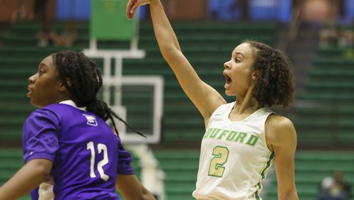 Buford guard Ava Grace Watson (2) reacts after a three-point attempt against Duluth guard Camyah Nolley (12) in the first half of their first round game of the GHSA Class 7A girls playoffs at the Buford Civic Center, on Tuesday, Feb. 21, 2023, in Buford, Ga.. Jason Getz / Jason.Getz@ajc.com)
