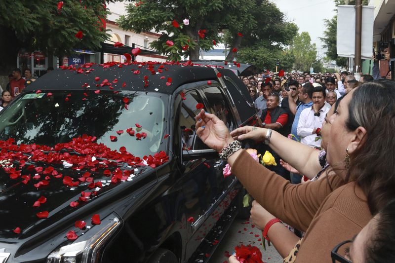 Supporters of slain Mayor Alejandro Arcos throw flowers during his funeral service, one week after he took office, in Chilpancingo, Guerrero state, Mexico, Monday, Oct. 7, 2024. (AP Photo/Alejandrino Gonzalez)