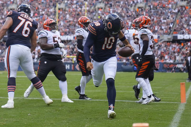 Chicago Bears quarterback Caleb Williams (18) carries the ball in for a touchdown during the first half of an NFL preseason football game against Cincinnati Bengals, Saturday, Aug. 17, 2024, at Soldier Field in Chicago. (AP Photo/Erin Hooley)