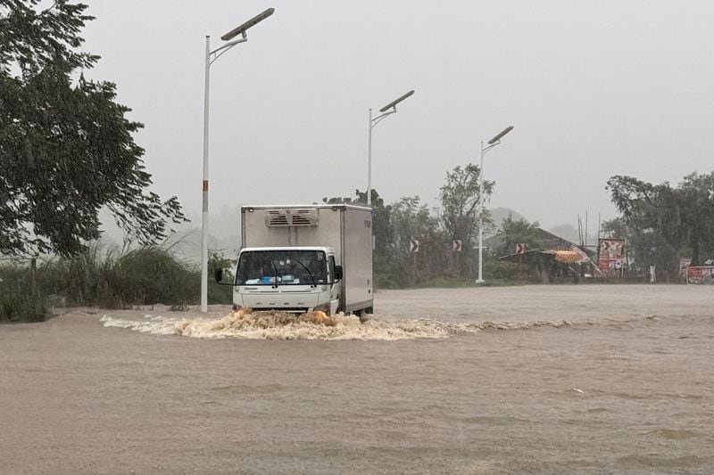 A truck negotiates flood waters caused by powerful Typhoon Krathon locally called "Typhoon Julian" at Bacarra, Ilocos Norte province, northern Philippines on Monday, Sept. 30, 2024. (AP Photo/Bernie Dela Cruz)