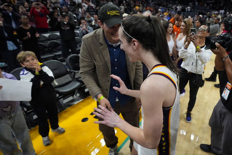 Indiana Fever guard Caitlin Clark greets Ashton Kutcher after a 78-73 win over the Los Angeles Sparks in a WNBA basketball game in Los Angeles, Friday, May 24, 2024. (AP Photo/Ashley Landis)