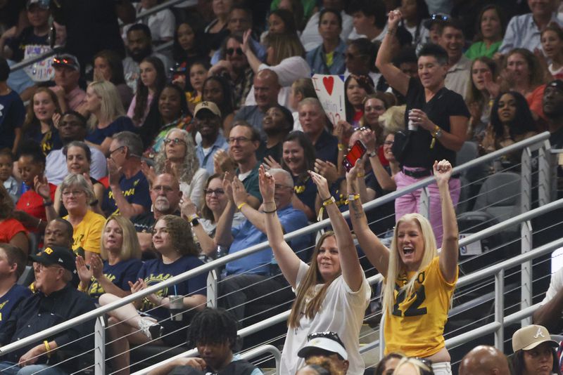 Fans of Indiana Fever guard Caitlin Clark react after she made a three-point basket during the second half against the Atlanta Dream at State Farm Arena, Friday, June 21, 2024, in Atlanta. Indiana won 91-79. (Jason Getz / AJC)
