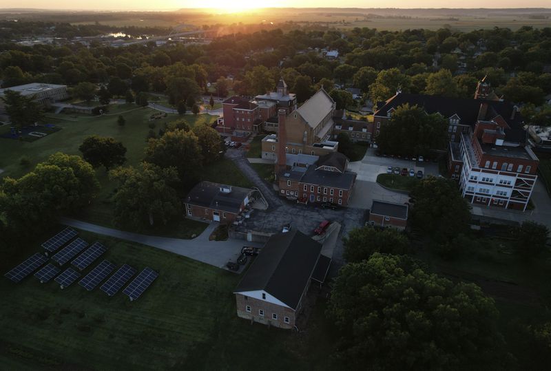 The sun rises over the grounds of the Mount St. Scholastica Benedictine sisters' monastery in Atchison, Kan., Wednesday, July 17, 2024. (AP Photo/Jessie Wardarski)