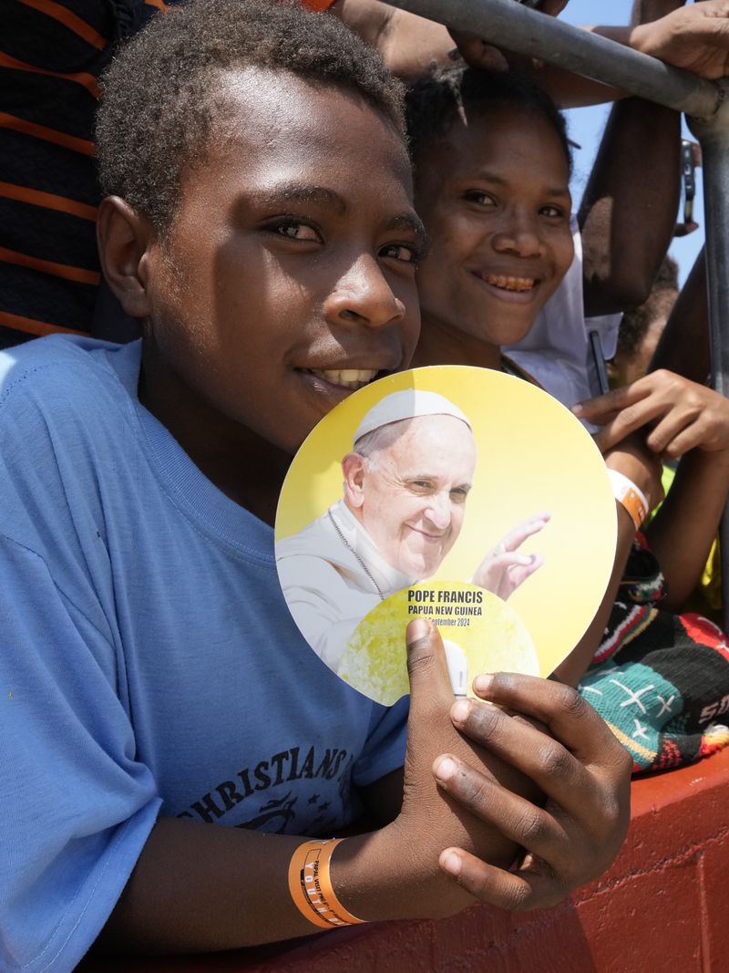 People smile as Pope Francis gives an address during meeting with young people in the Sir John Guise Stadium in Port Moresby, Papua New Guinea, Monday, Sept. 9, 2024. (AP Photo/Mark Baker)