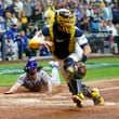 New York Mets' Jesse Winker slides safely home on a hit by Starling Marte Milwaukee Brewers catcher Gary Sánchez during the ninth inning of Game 3 of a National League wild card baseball game against the Milwaukee Brewers Thursday, Oct. 3, 2024, in Milwaukee. (AP Photo/Morry Gash)