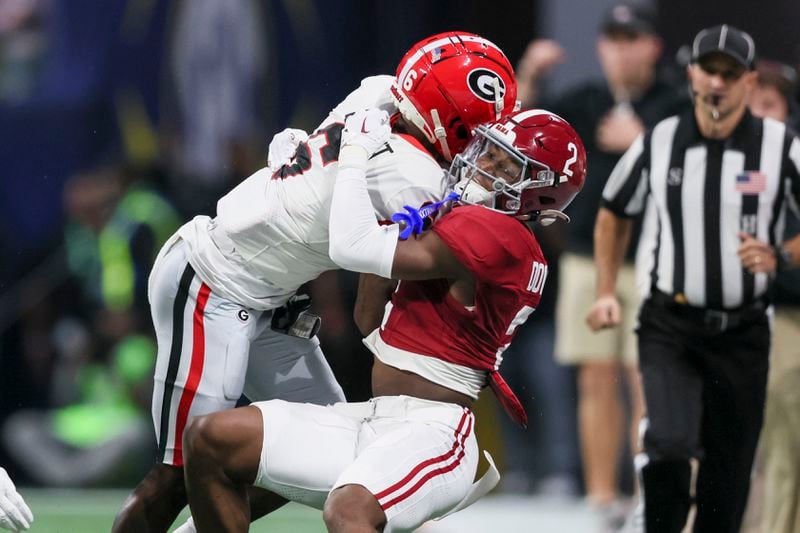 Alabama defensive back Caleb Downs (2) tackles Georgia wide receiver Dominic Lovett (6) during the first half of the SEC Championship football game at the Mercedes-Benz Stadium in Atlanta, on Saturday, December 2, 2023. (Jason Getz / Jason.Getz@ajc.com)
