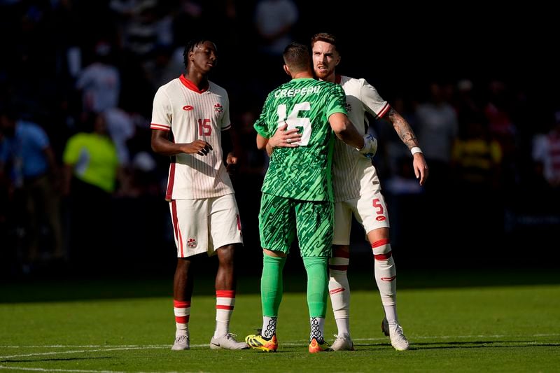 Canada defender Moïse Bombito (15), goalkeeper Maxime Crépeau (16) and defender Joel Waterman (5) celebrate after their international friendly soccer game against United States , Saturday, Sept. 7, 2024, in Kansas City, Mo. Canada won 2-1. (AP Photo/Charlie Riedel)