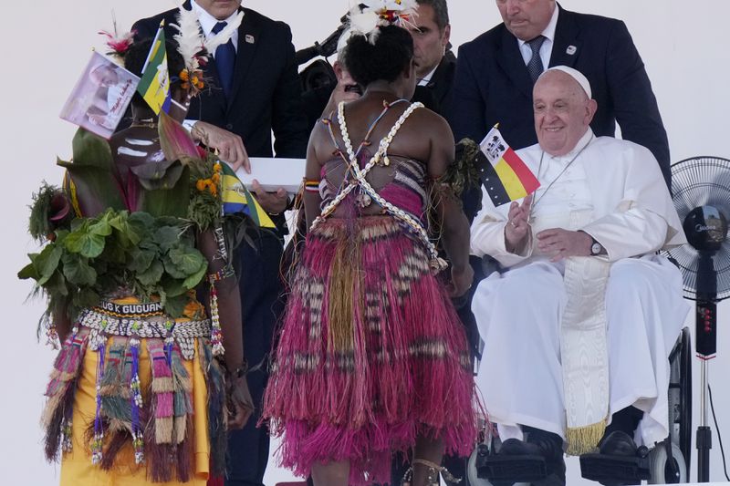 Pope Francis meets with people in traditional dress after giving an address during meeting with young people in the Sir John Guise Stadium in Port Moresby, Papua New Guinea, Monday, Sept. 9, 2024. (AP Photo/Mark Baker)