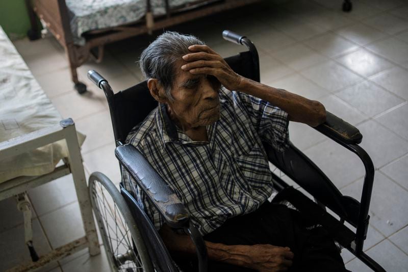 A man holds gestures at the Cogra nursing home amid high temperatures in Veracruz, Mexico, Sunday, June 16, 2024. Victims in Veracruz have made up nearly a third of Mexico's heat-related deaths as temperatures have reached 100 degrees in the humid Mexican gulf state. (AP Photo/Felix Marquez)