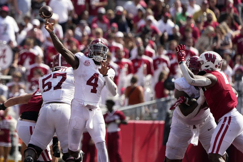 Alabama's Jalen Milroe (4) thorws a pass during the second half of an NCAA college football game against Wisconsin Saturday, Sept. 14, 2024, in Madison, Wis. (AP Photo/Morry Gash)