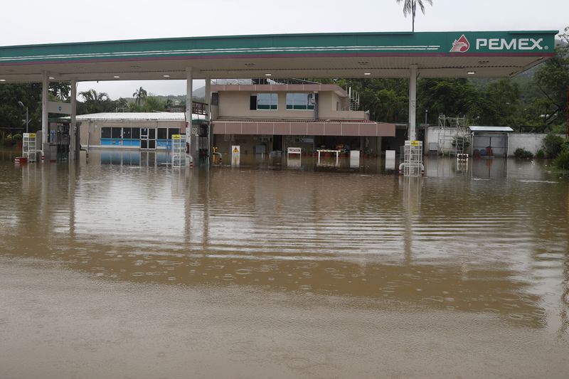 A gas station sits partially submerged by floodwaters in the aftermath of Hurricane John, in Acapulco, Mexico, Friday, Sept. 27, 2024. (AP Photo/Bernardino Hernandez)