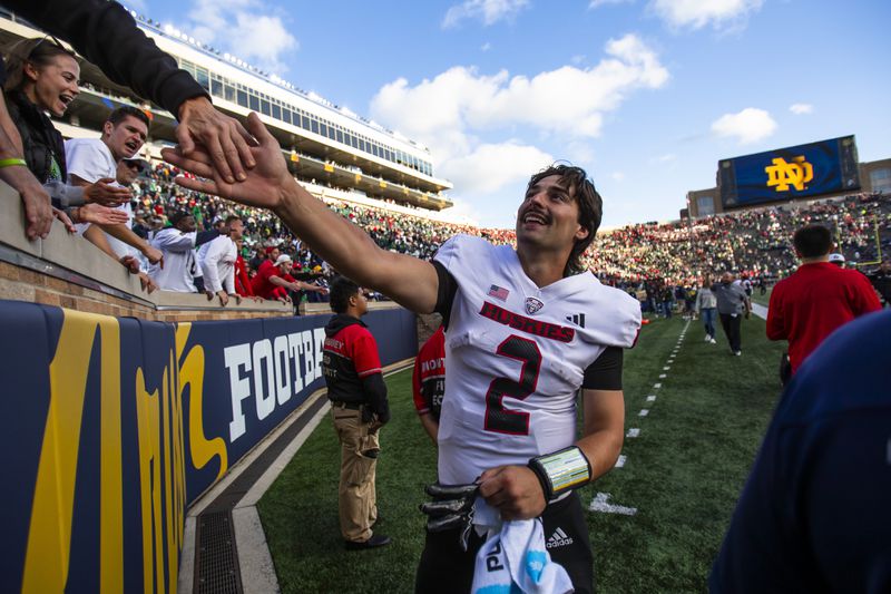 Northern Illinois quarterback Ethan Hampton (2) celebrates with fans after defeating Notre Dame in an NCAA college football game Saturday Sept. 7, 2024, in South Bend, Ind. (AP Photo/Michael Caterina)