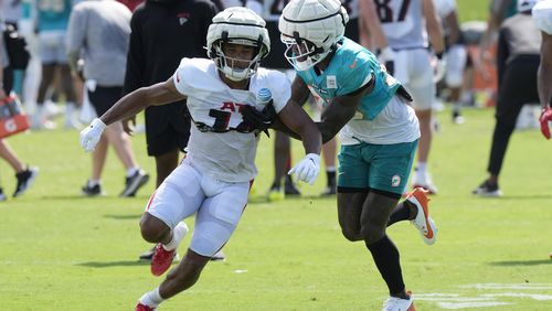 Miami Dolphins cornerback Siran Neal defends Atlanta Falcons wide receiver Rondale Moore (14) during a joint NFL football practice at the team's practice facility, Tuesday, Aug. 6, 2024, in Miami Gardens, Fla. (AP Photo/Marta Lavandier)