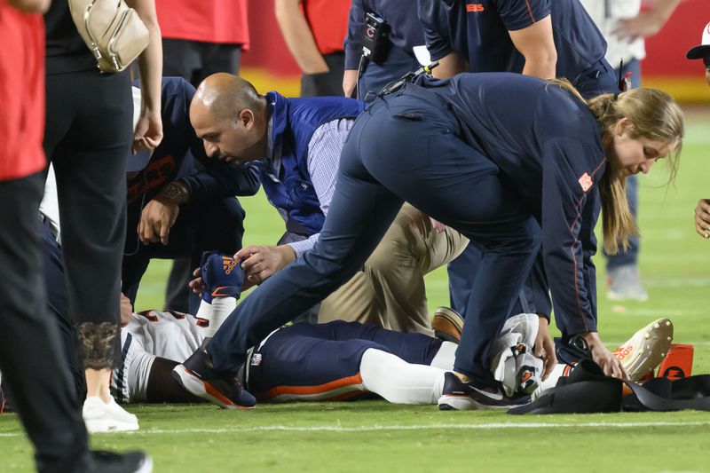 Chicago Bears safety Douglas Coleman III, bottom, is treated on the field after being injured during the second half of a preseason NFL football game against the Kansas City Chiefs, Thursday, Aug. 22, 2024 in Kansas City, Mo. (AP Photo/Reed Hoffmann)