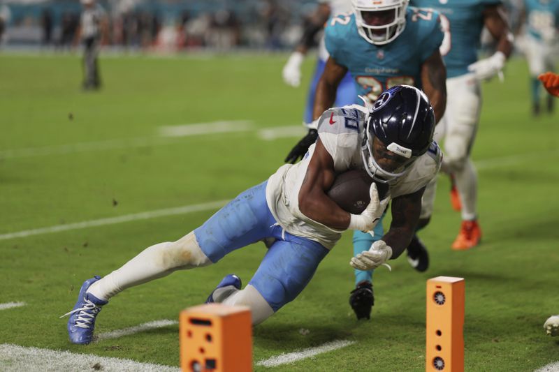 Tennessee Titans running back Tony Pollard (20) scores a touchdown during the second half of an NFL football game against the Miami Dolphins, Monday, Sept. 30, 2024, in Miami Gardens, Fla. (AP Photo/Brennan Asplen)