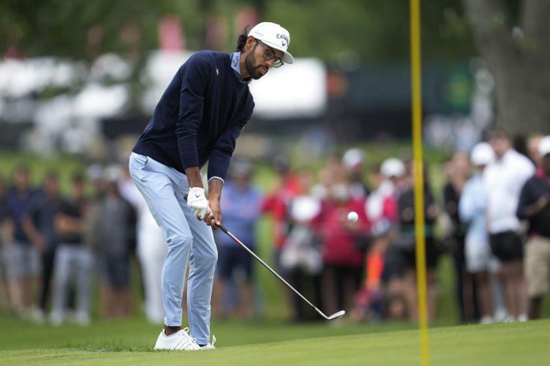Akshay Bhatia chips onto the third green during the final round of the Rocket Mortgage Classic golf tournament at Detroit Country Club, Sunday, June 30, 2024, in Detroit. (AP Photo/Paul Sancya)