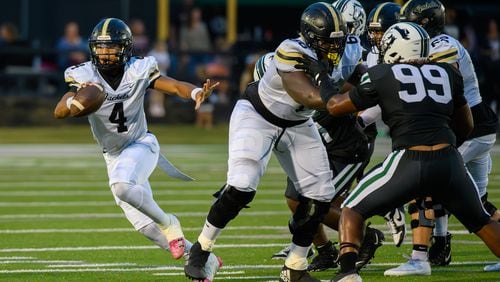 Jaden Duckett, quarterback for Sprayberry High School, runs the ball during the Sprayberry at Kennesaw Mountain high school football game in Kennesaw, GA on August 30, 2024. (Jamie Spaar for the Atlanta Journal Constitution)