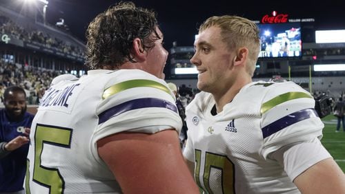 Georgia Tech Yellow Jackets offensive lineman Connor Scaglione (65) celebrates with Georgia Tech Yellow Jackets quarterback Haynes King (10) after Tech won an NCAA college football game between Georgia Tech and Syracuse, 31-22, in Atlanta on Saturday, Nov. 18, 2023.  (Bob Andres for the Atlanta Journal Constitution)