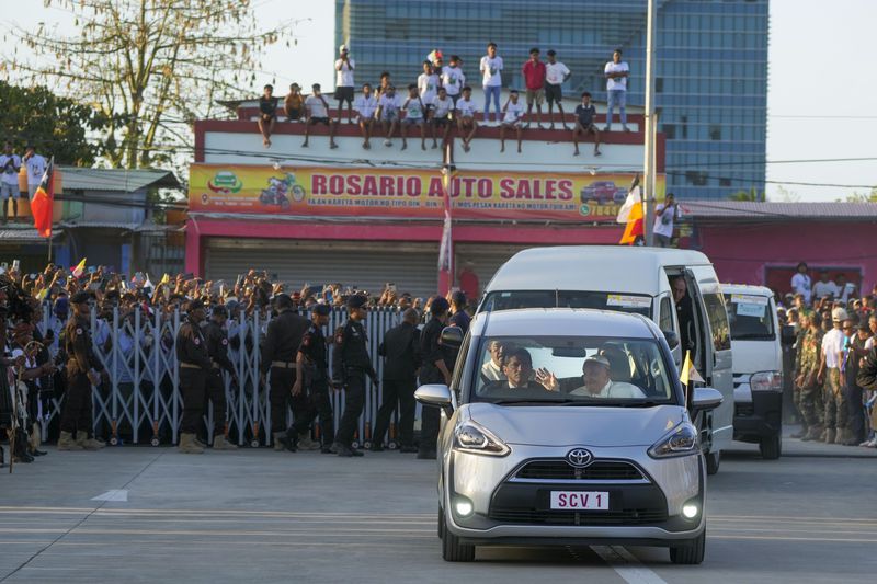 Pope Francis waves from his car as he arrives at the Presidential Palace for a welcome ceremony with President José Manuel Ramos-Horta in Dili, East Timor, Monday, Sept. 9, 2024. In East Timor Francis had to negotiate perhaps the most sensitive issue clouding his visit to Asia and Oceania: the case of Bishop Carlos Ximenes Belo, the revered national hero who won the Nobel Peace Prize for his nonviolent independence campaign. (AP Photo/Gregorio Borgia)