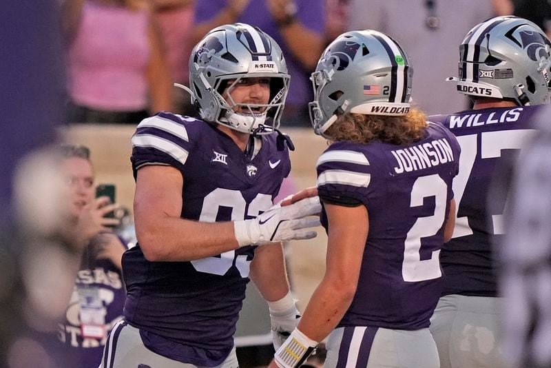 Kansas State tight end Will Swanson, left, celebrates with quarterback Avery Johnson (2) after scoring a touchdown during the first half of an NCAA college football game against Arizona Friday, Sept. 13, 2024, in Manhattan, Kan. (AP Photo/Charlie Riedel)