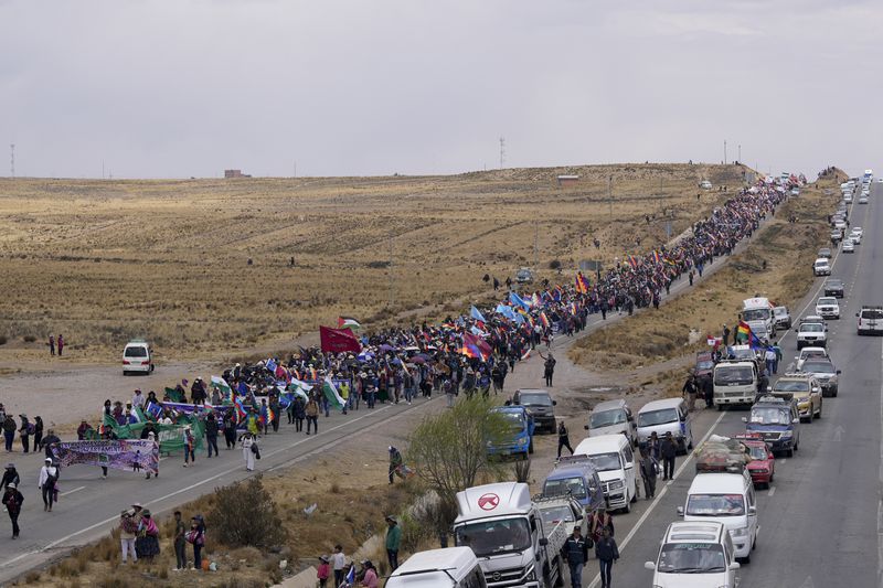 Supporters of former President Evo Morales march to the capital to protest the government of current President Luis Arce near El Alto, Bolivia, Sunday, Sept. 22, 2024. (AP Photo/Juan Karita)