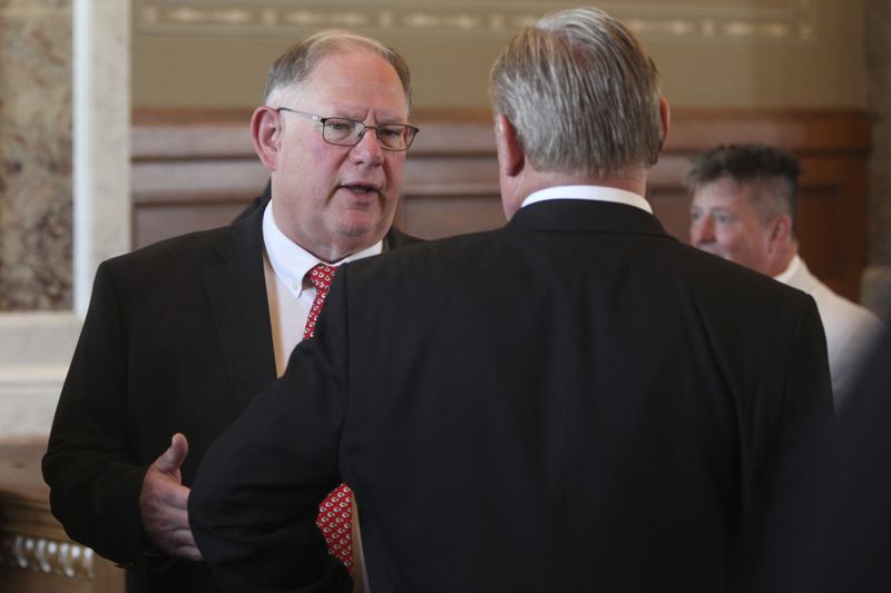Kansas House Speaker Dan Hawkins, left, R-Wichita, confers with House Commerce Committee Chair Sean Tarwater, R-Stillwell, ahead of a meeting of GOP lawmakers on a proposal to help the Kansas City Chiefs build a new stadium in Kansas, Tuesday, June 18, 2024, at the Statehouse in Topeka, Kan. The plan would allow the state to issue bonds to help pay for a new stadium for the Chiefs and professional baseball's Kansas City Royals. (AP Photo/John Hanna)